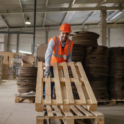 man-working-with-heavy-wooden-materials