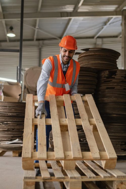 man-working-with-heavy-wooden-materials